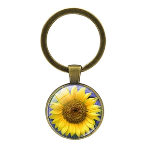 Vintage bronze sunflower time gem keychain with golden flower and blue background