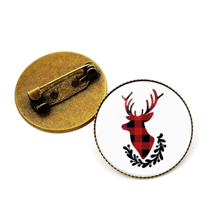 Christmas buffalo plaid brooch featuring a reindeer silhouette and black laurel wreath design