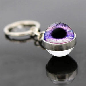 Double-sided glass ball keychain with purple evil eye design and silver metal ring