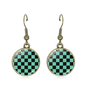 Green and black checkered glass gem earrings with bronze hooks in a minimalist design