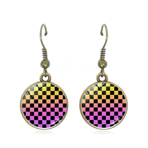 Detail of vintage checkerboard drop earrings with bronze finish and glass patterns