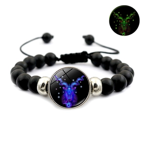 Detail of adjustable black beaded Capricorn bracelet showing its luminous green glow effect