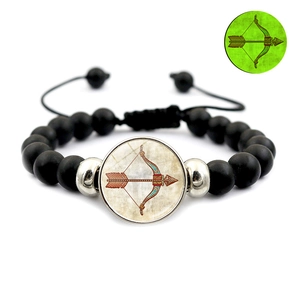 Glow-in-the-dark zodiac beaded bracelet detail with adjustable black cord and luminous charm