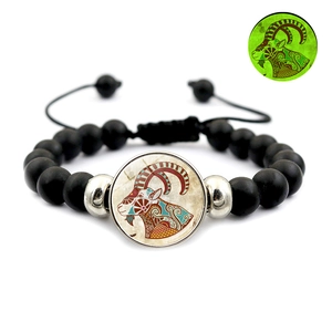 Glow-in-the-dark Capricorn constellation matte black bead bracelet with silver accents