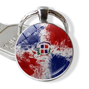 Detailed close-up of Dominican Republic flag keychain with glass dome and alloy base