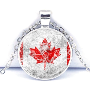 Detailed close-up of a circular pendant featuring a distressed Canadian flag design