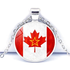 Detail of silver Canada maple leaf and star pendant with glass dome and cross chain