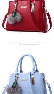 Detailed view of leather handbags in wine red and sky blue with plush ball charms