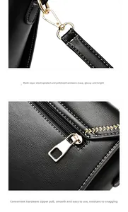 Detail of gold-plated hardware and white stitching on a black leather handbag