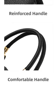 Nahaufnahme verstärkter Griffe an schwarzer Lederhandtasche mit litchi-muster und Golddetails