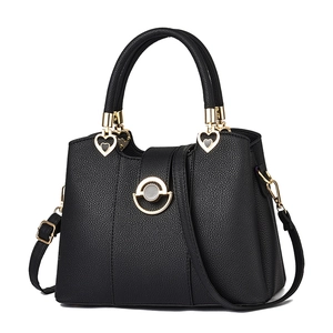 Elegante schwarze Handtasche mit Lychee-Maserung, Goldbeschlägen und Herz-Anhänger-Detail