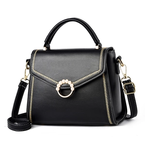 Elegant black leather top handle crossbody bag with gold hardware and pearl buckle