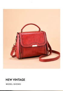 Close-up of vintage red handbag with retro texture, gold hardware and leather handle