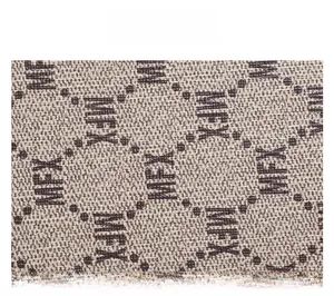 Macro shot of durable beige jacquard fabric featuring brown MFX monogram pattern
