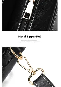 Detailed macro view of premium gold metal zipper and strap buckle on a black leather handbag