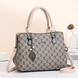 Large beige monogram handbag for women with metallic leaf charm and detachable strap