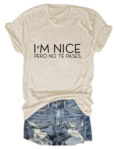 Detail of oat-colored cotton T-shirt with black slogan print and distressed denim shorts