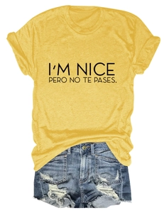 Detail of yellow graphic tee with black lettering and distressed blue denim shorts