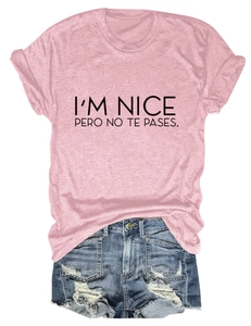 Close-up of pink tee with I'M NICE slogan and distressed blue denim shorts set