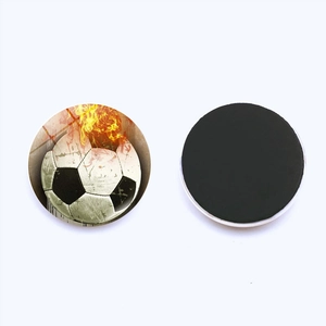 Magnetic glass fridge magnet set featuring a cool flaming soccer ball on white background