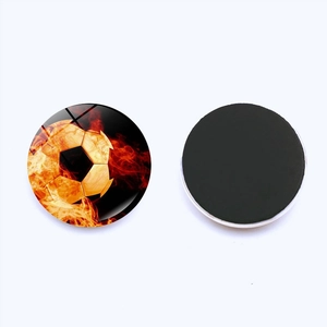 Detailed view of 25mm soccer fridge magnet with flame pattern and black magnetic back