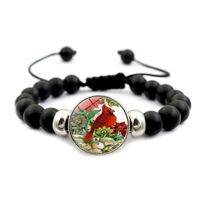 Detailed macro view of black beaded bracelet with cardinal bird charm and adjustable cord