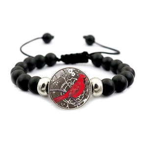 Adjustable black beaded bracelet with red cardinal bird motif on a round metal charm