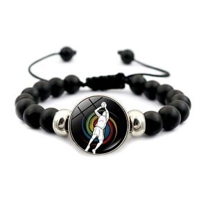 Détail du bracelet de basket en perles mates noires avec cordon ajustable et breloque sport