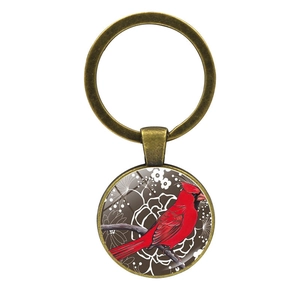 Détail du porte-clés cardinal en bronze vintage avec pendentif en verre et motif floral
