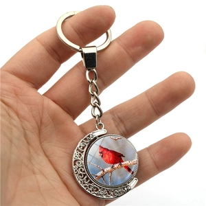 Rotating cardinal bird moon keychain with double-sided glass gem and silver alloy finish
