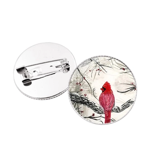 Macro view of cardinal bird time gem brooch pins with silver metal backings