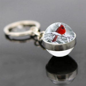 Double-sided glass ball cardinal bird keychain with silver metal ring and snow branch art