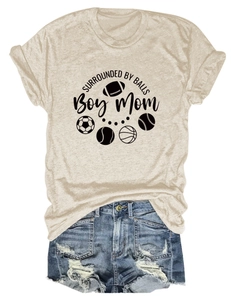 Flat lay of women's Boy Mom T-shirt with sports ball prints and ripped denim shorts