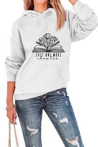 Close-up of JUST ONE MORE CHAPTER print on a white hoodie with floral book graphics