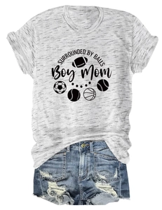 Detail of grey heather Boy Mom t-shirt with sports ball icons and ripped denim shorts