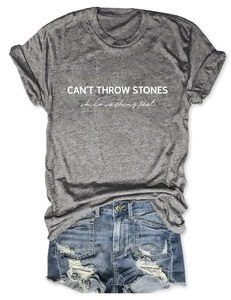 Detail view of cotton t-shirt with letter print and distressed denim shorts flat lay
