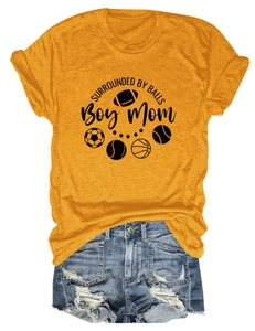Flat lay of yellow t-shirt with sports balls print and denim shorts on white background