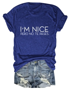 Detailed view of the I'M NICE slogan print and distressed denim short hem textures