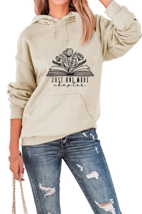 Detail of Just One More Chapter print on cream hoodie with drawstring and kangaroo pocket