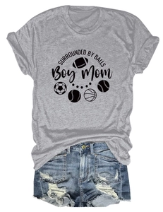 Detail of grey Boy Mom t-shirt with sports ball icons and distressed denim shorts