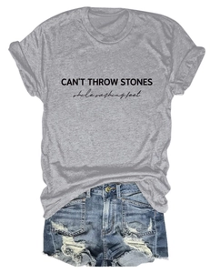 Detail of CAN'T THROW STONES print on grey t-shirt with ripped denim shorts