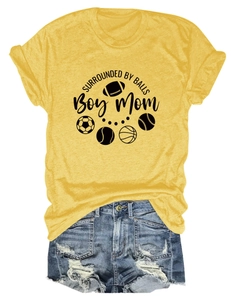 Detail of yellow round neck t-shirt with sports graphics and ripped denim shorts