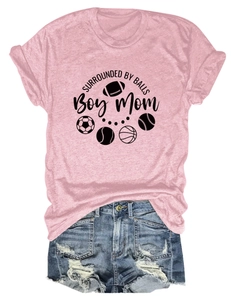 Close-up of pink Boy Mom t-shirt with sports ball graphics and blue denim shorts