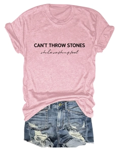 Detail of pink cotton t-shirt with black letter print and blue denim shorts
