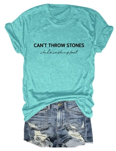 Detail of CAN'T THROW STONES print on heather teal t-shirt with ripped denim shorts