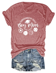 Flat lay of a red cotton t-shirt with sports ball icons and distressed denim shorts