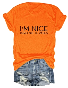 Detail of orange t-shirt with black slogan and distressed denim shorts set