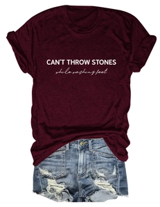 Detail of CAN'T THROW STONES print on wine red T-shirt and ripped denim shorts combo