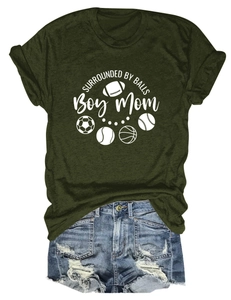 Flat lay of olive green crewneck t-shirt with sports graphics and distressed denim shorts