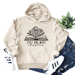 Detail of floral book graphic and JUST ONE MORE CHAPTER text on cream hoodie